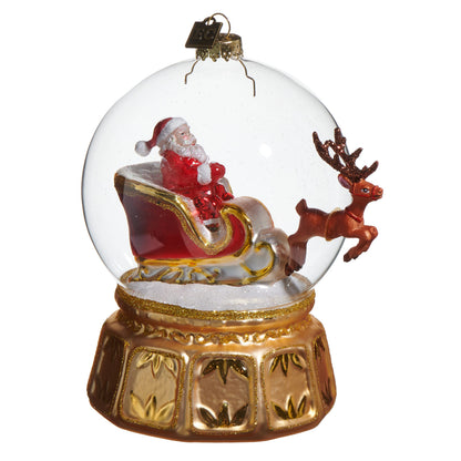 Snow Globe Express Ornament, A glass ornament showing Santa in his sleigh pulled by a reindeer, set on a gold pedestal base.