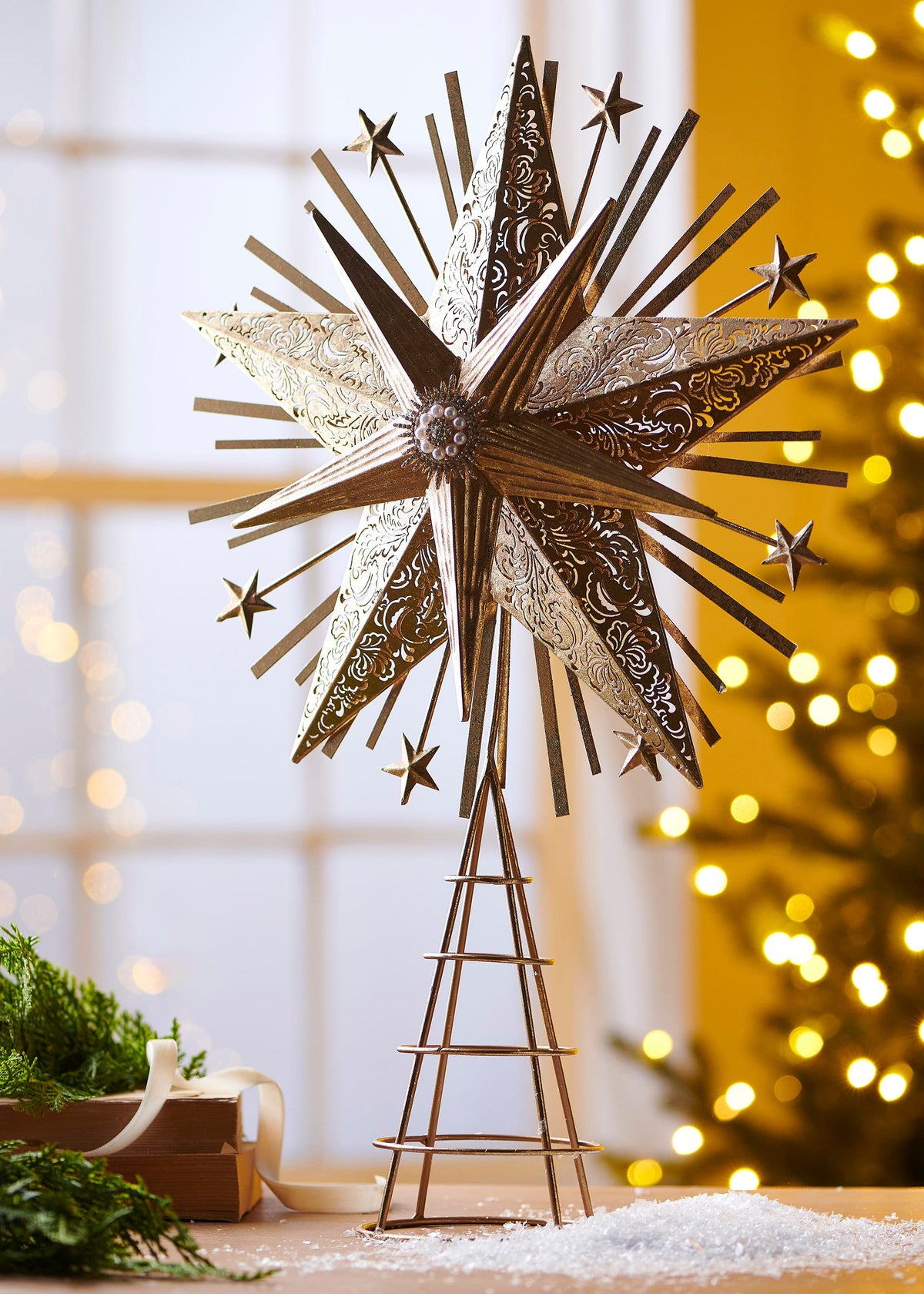 Starburst Tree Topper, An antique gold iron starburst tree topper with pierced scroll patterned points, smaller stars on wire spikes, and a pearl and rhinestone center medallion.