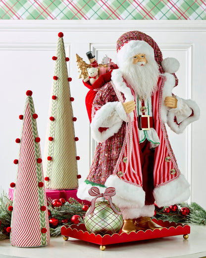 Sugar and Spice Santa, A large Santa figure in a pink and red striped coat with white fur trim, gold boots, and a jeweled belt, carrying a sack of toys over one shoulder.