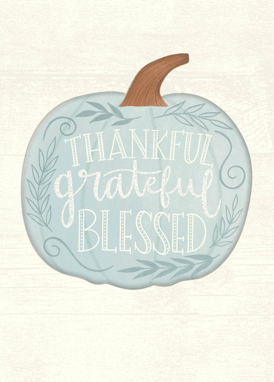 Thankful Grateful Blessed Greeting Card, A cream card front with a pale blue pumpkin carrying the words Thankful, grateful and Blessed in white lettering, framed by leafy sprigs and scrolls.