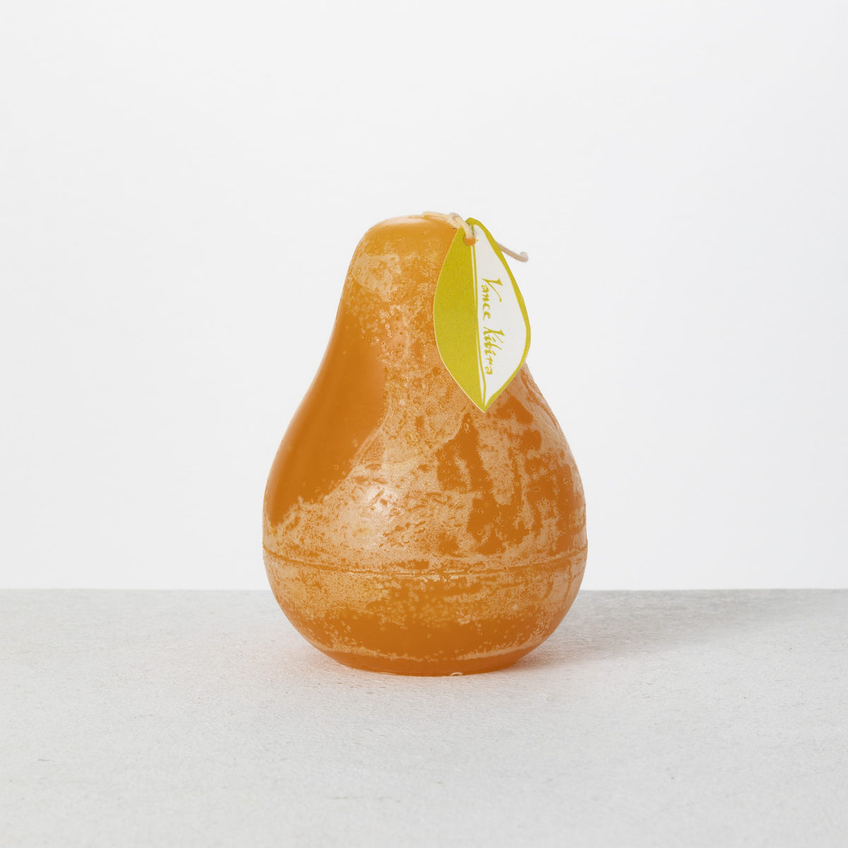 Timber Pear Candle 3 x 4 Inch, A green pear shaped candle with a textured surface stands tied with a small leaf shaped hang tag.