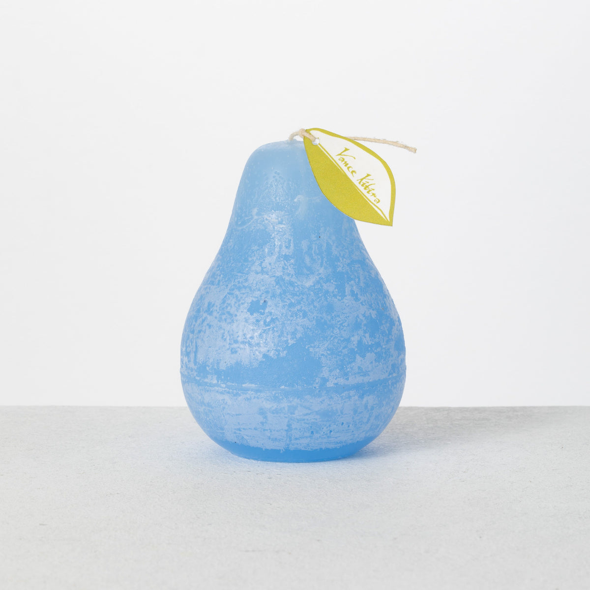 Timber Pear Candle 3 x 4 Inch, A green pear shaped candle with a textured surface stands tied with a small leaf shaped hang tag.