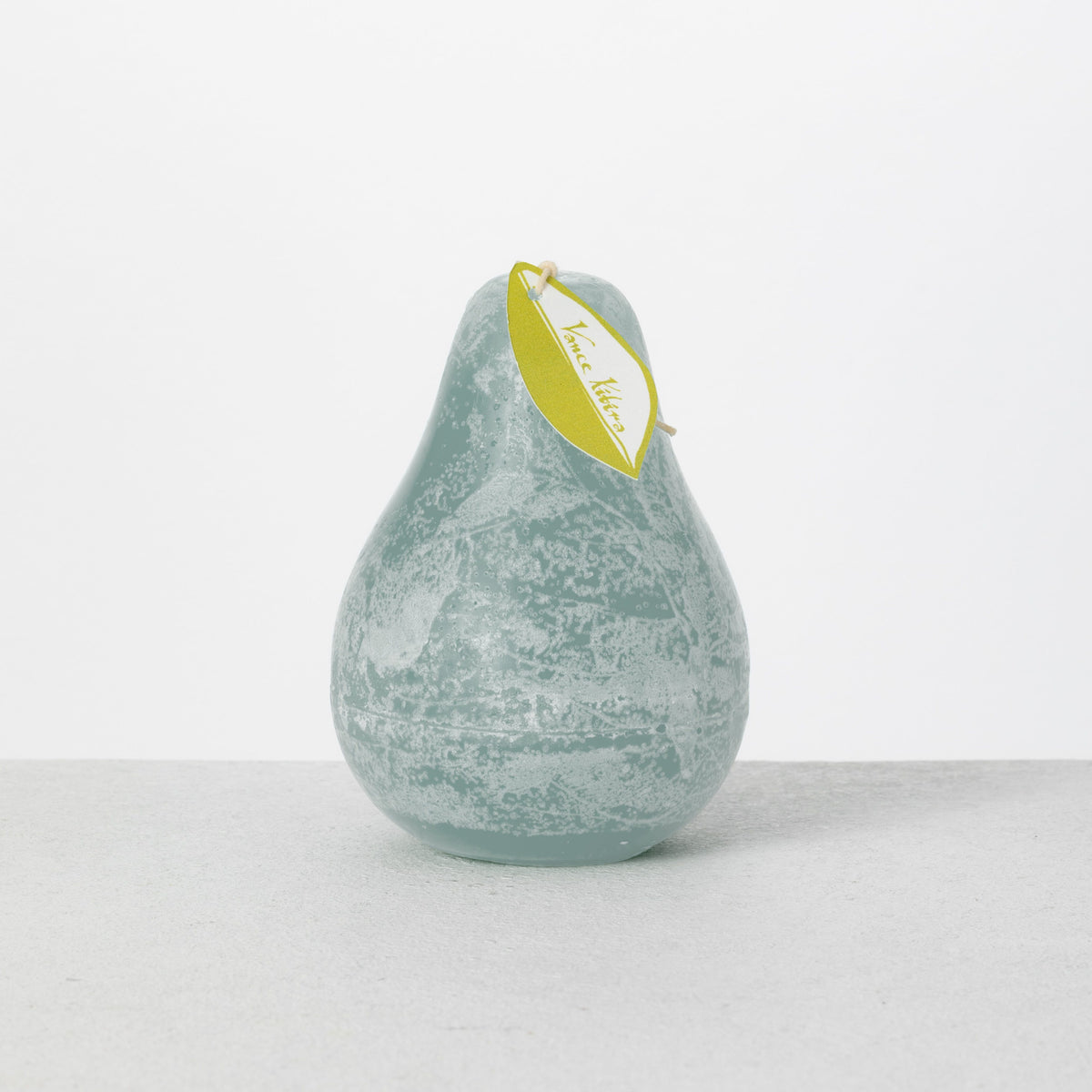 Timber Pear Candle 3 x 4 Inch, A green pear shaped candle with a textured surface stands tied with a small leaf shaped hang tag.
