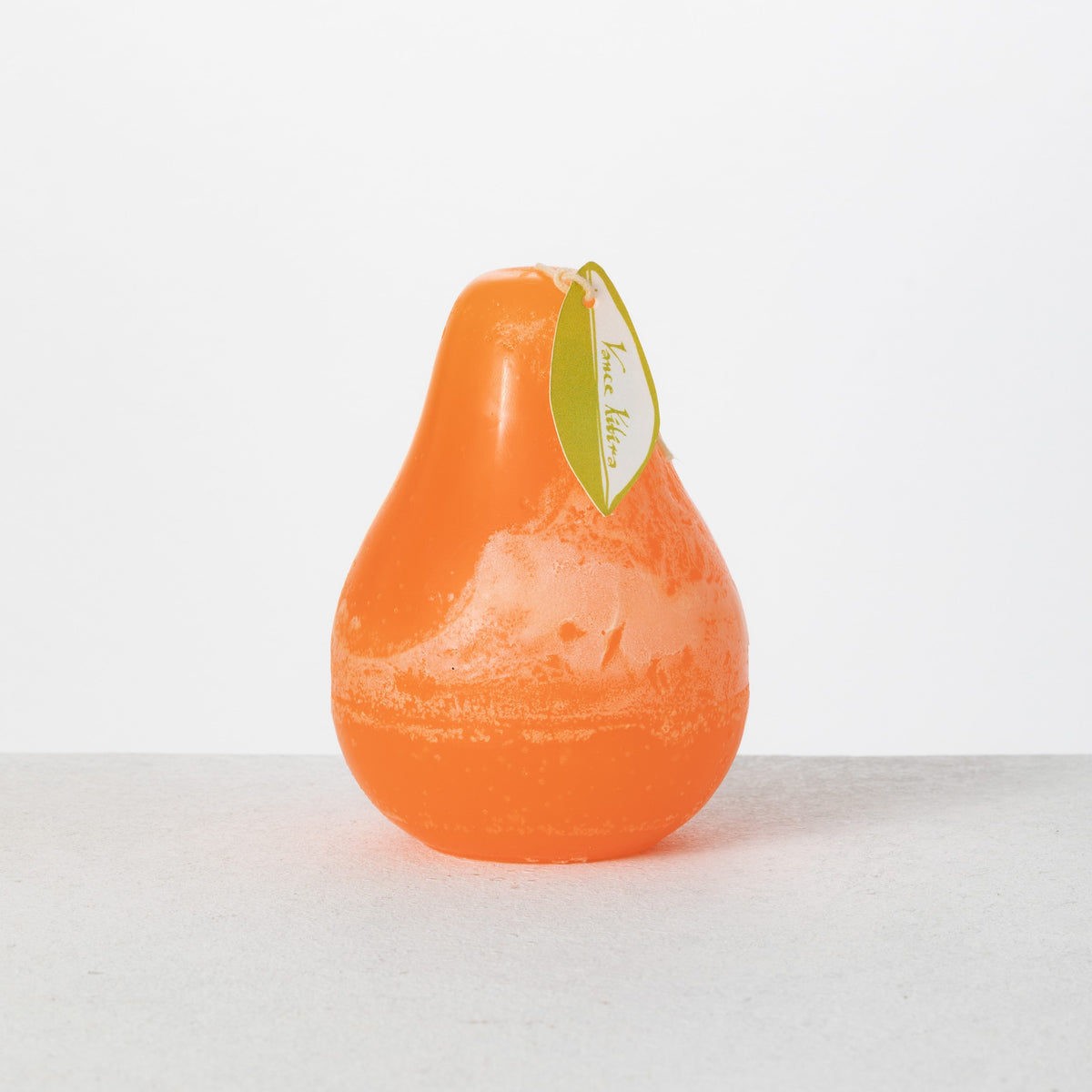 Timber Pear Candle 3 x 4 Inch, A green pear shaped candle with a textured surface stands tied with a small leaf shaped hang tag.