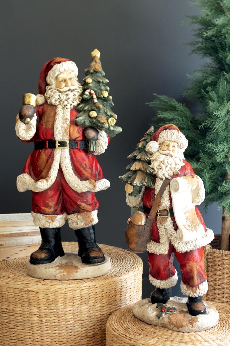 Traditional Faux Concrete Santa with Bell, A tall faux concrete Santa figure in a red suit holding a small Christmas tree.