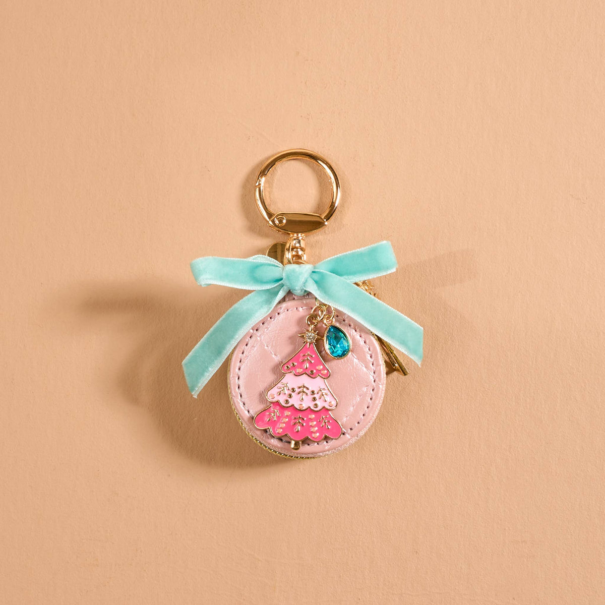 Travel Jewelry Case Bag Charm, A tan round zip case charm with a green gingham bow, a pearl, a gold bee, and a honeycomb charm, in the Hey Honey design.