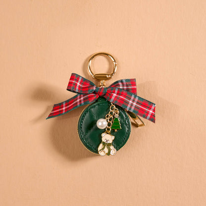 Travel Jewelry Case Bag Charm, A tan round zip case charm with a green gingham bow, a pearl, a gold bee, and a honeycomb charm, in the Hey Honey design.