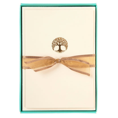 La Petite Presse Tree Boxed Notes, A cream notecard with a gold foil tree of life icon, tied with a bronze ribbon inside a teal box.