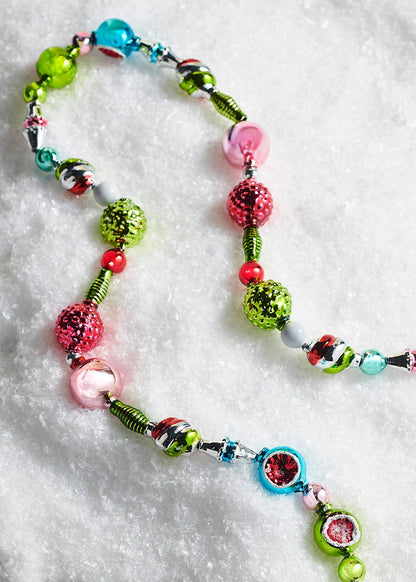 Vintage Style Glass Bead Garland, A multicolor glass bead garland in red, green, rose, silver and turquoise, shown in a close view beside its full length.