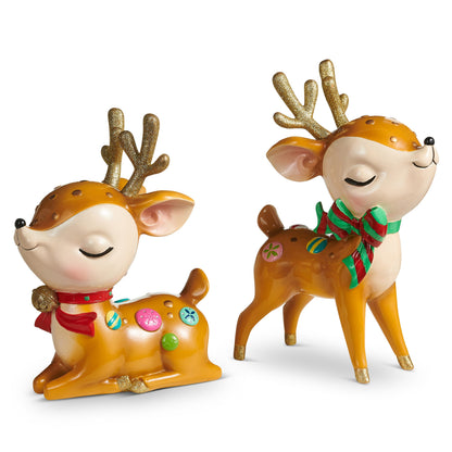 Whimsical Retro Reindeer Figurine with Glitter Antlers, Two retro resin reindeer with gold glitter antlers and closed, smiling eyes, one sitting with a red scarf and bell and one standing with a red and green striped bow.