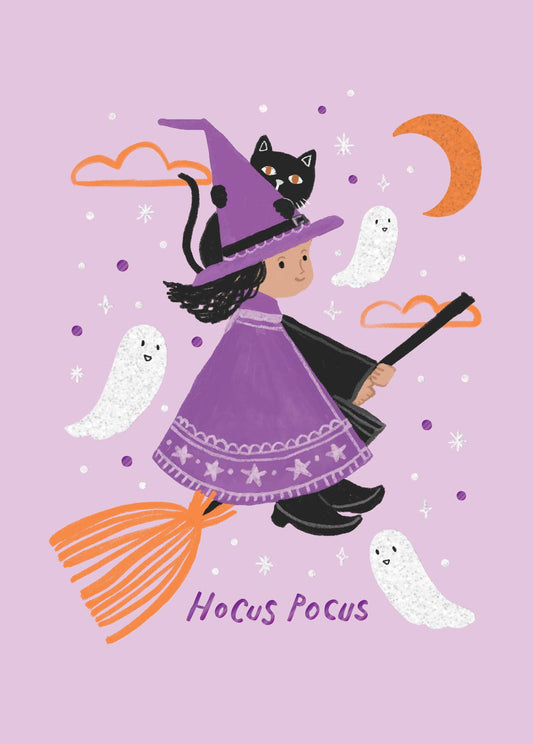 Witchy Whimsy Greeting Card, Front of the card showing a young witch in a purple cape riding an orange broom with a black cat on her hat, three white ghosts, an orange crescent moon and the words Hocus Pocus on a lilac ground.