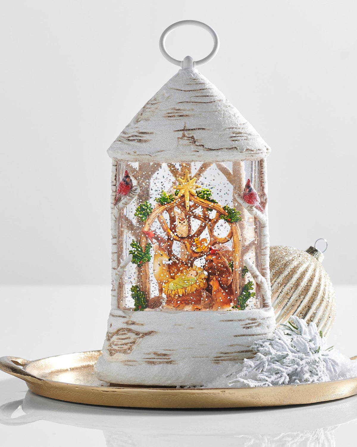 Woodland Nativity Lighted Water Birch Lantern, White birch-bark water lantern with a ring handle, showing the Christ Child in a manger surrounded by a deer, bear, fox, owl and cardinals.