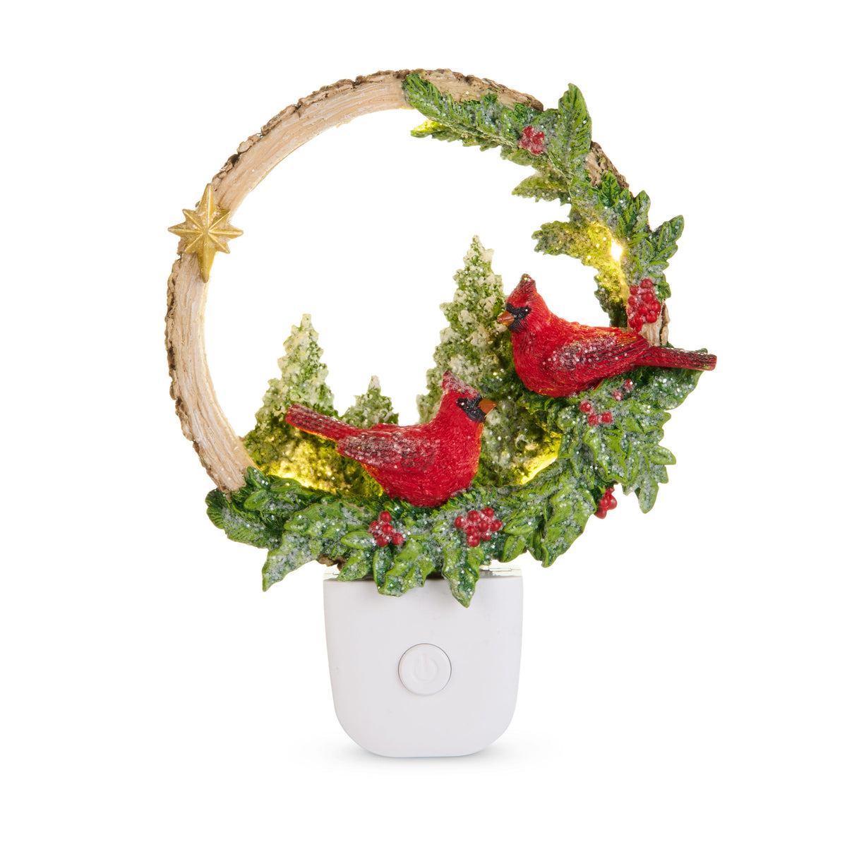 Woodland Noel Cardinals Night Light, A resin wreath night light with two red cardinals, snow dusted holly and pine, and a gold star, lit from within on a white plug in base with an on off button.